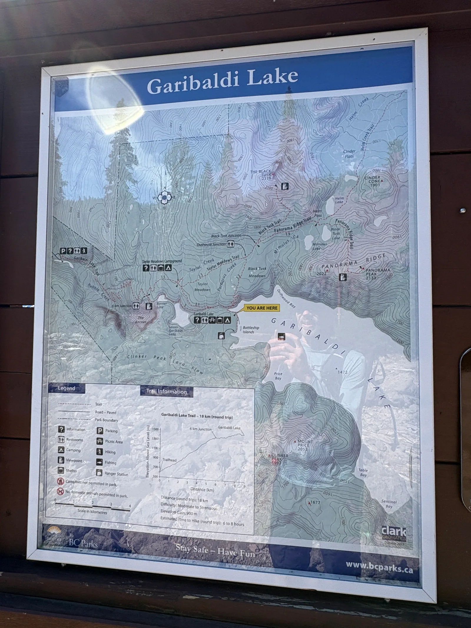 Trail map signboard at Garibaldi Lake showing the surrounding trail network and elevation profile
